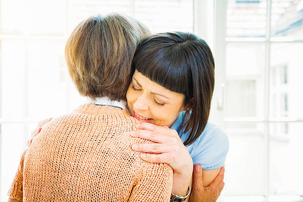 istock Mature daughter hugs her senior mother smiling in support 628390538