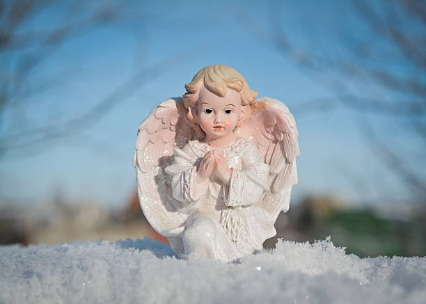 Guardian angel on blue sky background One Guardian angel on blue sky background. Religion and faith concept Winter time. friedrich engels stock pictures, royalty-free photos & images