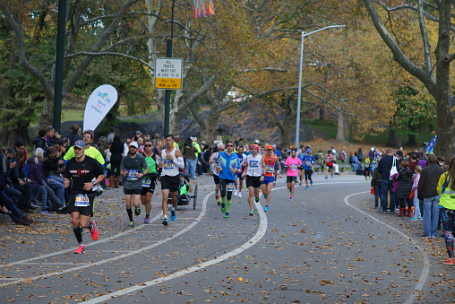 New York City, NY, USA - November 6, 2016: Marathoners and spectators at 24th mile in Central Park, New York City Marathon