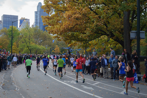 New York City, NY, USA - November 6, 2016: Marathoners and spectators at 24th mile in Central Park, New York City Marathon