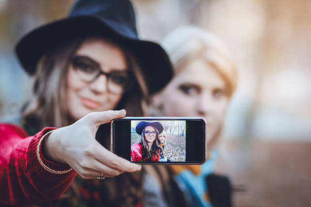 istock Two female friends taking a selfie with smartphone 628398364