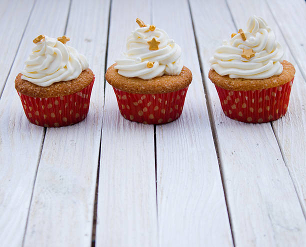 istock Cupcakes with mascarpone cream and gold decoration 628399196