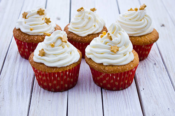 istock Cupcakes with mascarpone cream and gold decoration 628399786