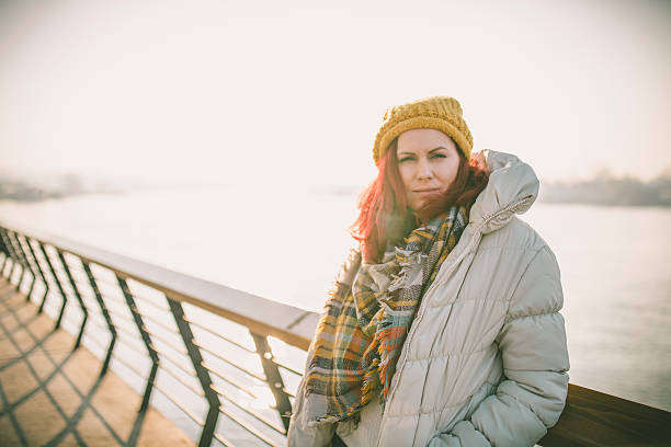 istock Beautiful girl walking alone along the river on autumn day 628400122