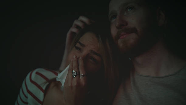 istock Women crying while watching movie in a cinema hall 628401340