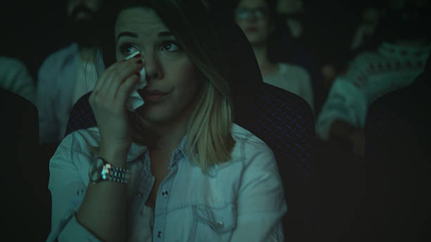 women crying while watching movie in a cinema hall - audience surprise movie theater shock imagens e fotografias de stock
