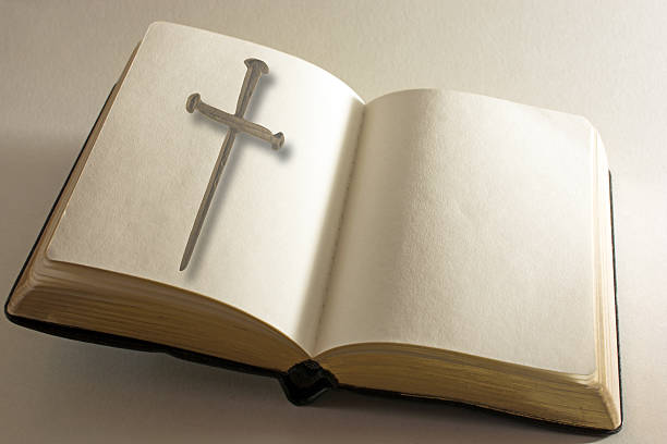 istock Open book with blank pages and cross of nails 628409418