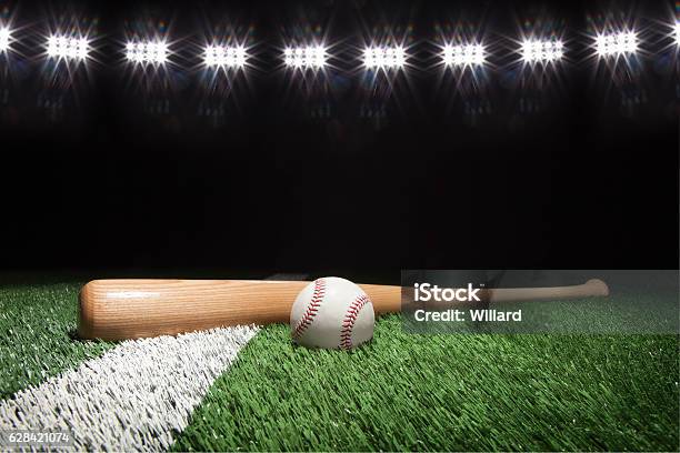 Baseball And Bat At Night Under Stadium Lights Stock Photo - Download Image Now - Baseball - Sport, Baseball - Ball, Backgrounds