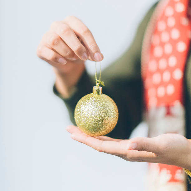 istock Beautiful woman with christmas bauble on a light background 628427812