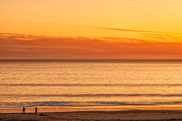 istock Beach and Ocean at Sunset with Unrecognizable People 628428256
