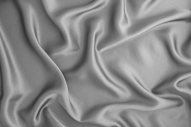 istock Close up wave gray silk or satin fabric background 628434072