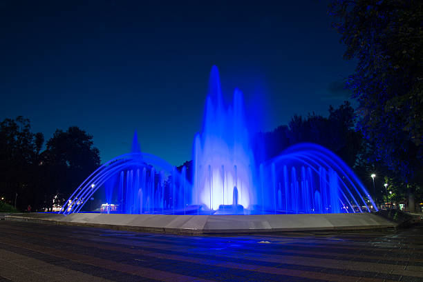 istock Water fountain illuminated with lights at night 628436744