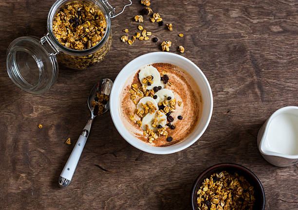 pumpkin smoothie bowl with banana and granola - yoghurt chocolate bowl bildbanksfoton och bilder