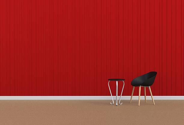 istock Black chair in a red room 628437524