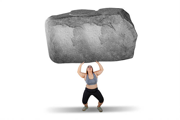 istock Fat woman lifting big stone 628437764