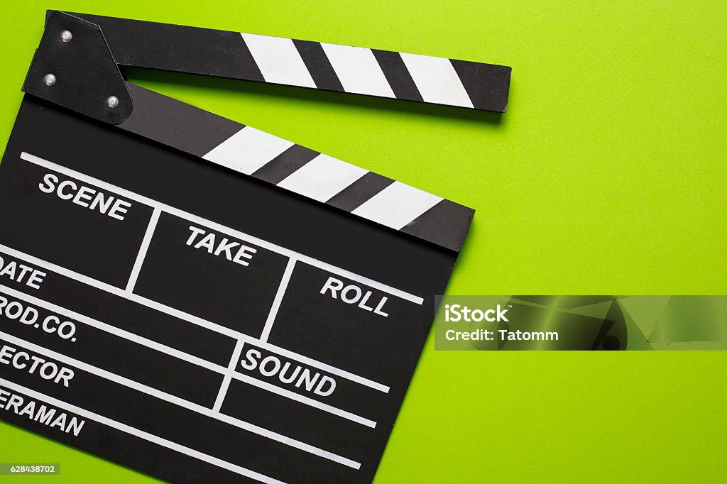 movie clapper on green background Film Slate Stock Photo