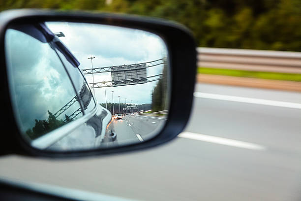 istock Road reflected in side mirror of car 628439634