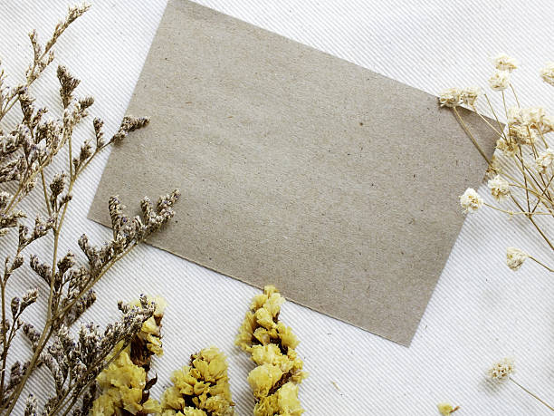 istock paper with dried flowers and space copy background top view 628439820
