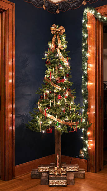 istock Victorian Christmas Tree against Navy Blue Wall 628440260