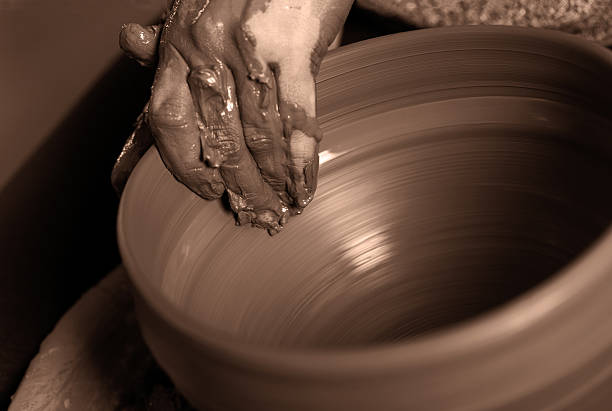 istock Potter shaping clay on the pottery wheel 628440768