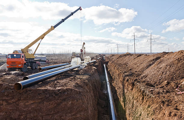 istock construction of a pipeline in difficult weather conditions 628441548