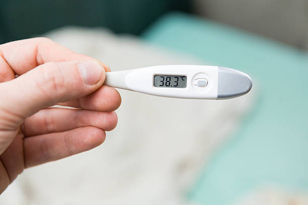 istock Male hands holding a digital thermometer 628452498