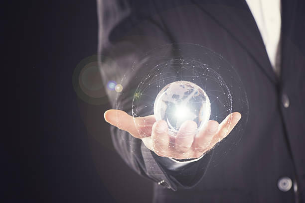istock holding a glowing earth globe in his hands 628462758