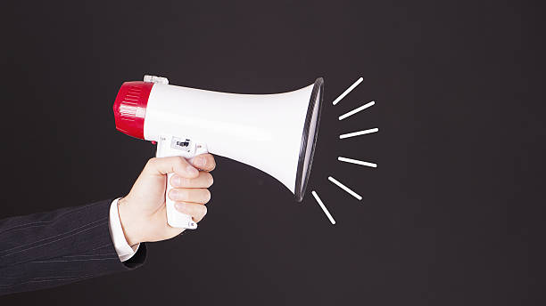 istock Woman holding a white and red megaphone in his hand. 628463466