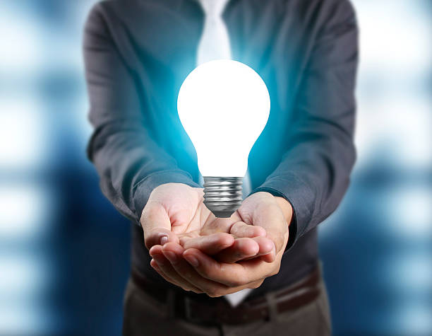 istock business person holding light bulb 628464628