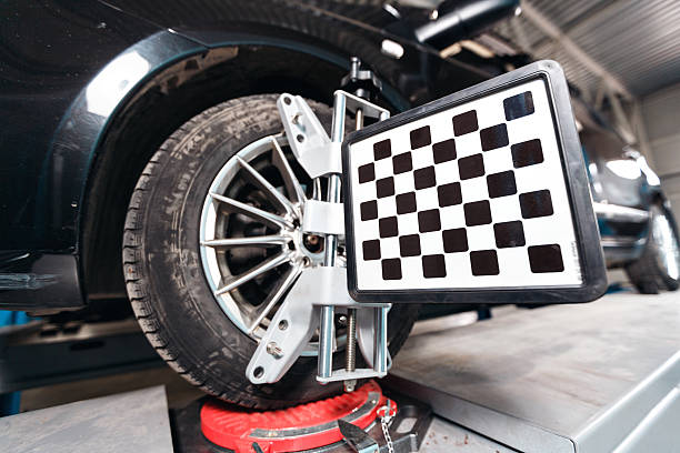 istock Car on stand with sensors wheels for alignment camber check 628470428