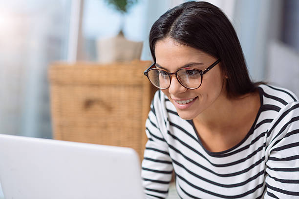 istock Delighted woman using the laptop at home 628470510