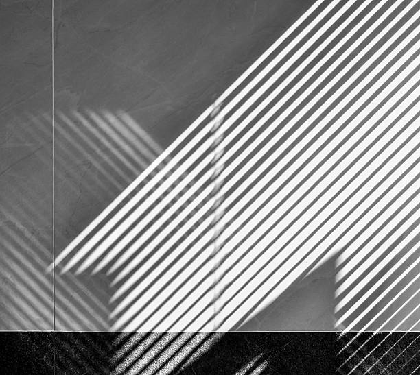 istock Abstract of window screen shadow on bathroom wall. 628470698