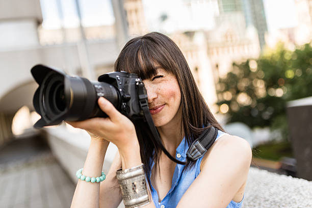 istock brunette tourist with a camera in Montreal - Canada 628471158