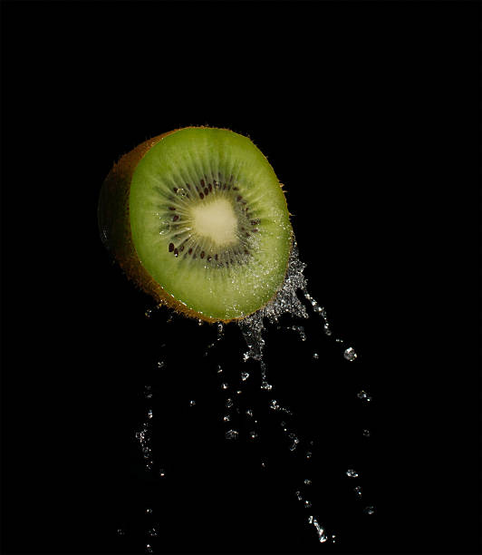 Fresh kiwi splash in water to movement