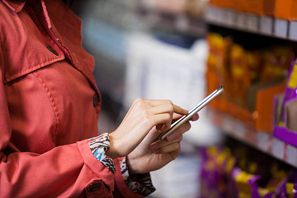 istock Mid section of woman using mobile phone 628482708