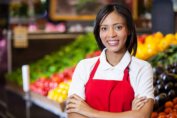 istock Smiling female staff standing with arms crossed in organic section 628482814