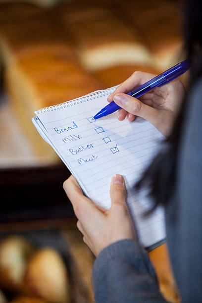 istock Mid section of woman marking on checklist 628483446