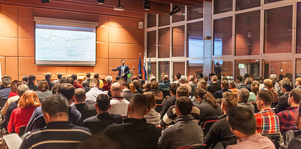 Business speaker giving a talk in conference hall. stock photo