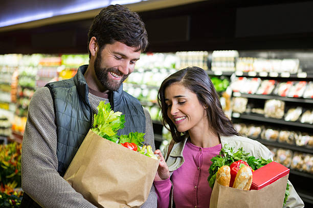 istock Smiling couple shopping for vegetables in organic section 628483672