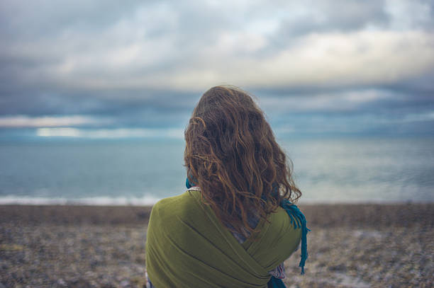 istock Young woman looking at the sea 628490644