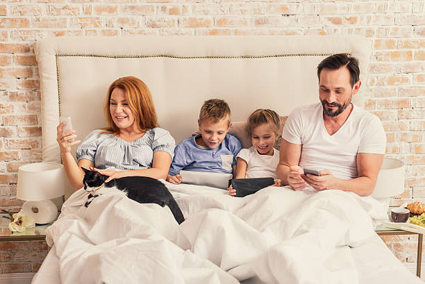 istock Family enjoying gadgets at home 628496764
