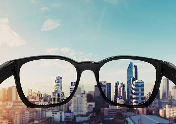 istock Eye glasses looking to city view, focused on glasses lens 628497968