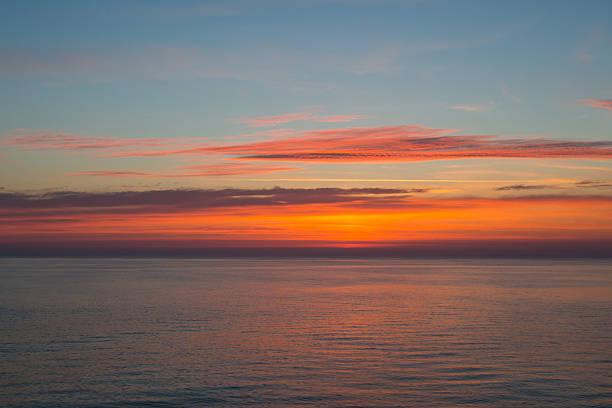 istock Sunset at sea with clouds and horizon 628498382
