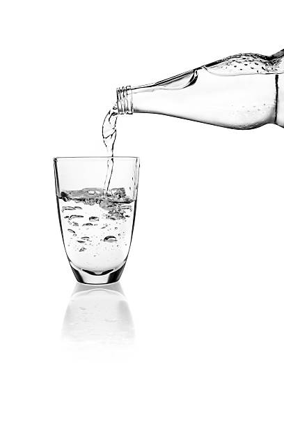 istock Water pouring into a glass on a white background 628504334
