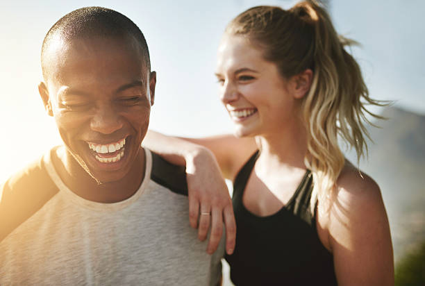 Fit couple relationship goals Shot of a fit young couple working out together outdoors friends laughing stock pictures, royalty-free photos & images