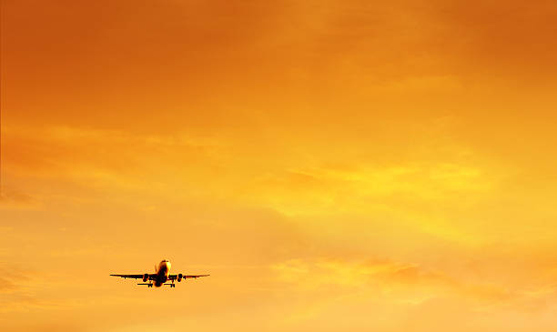 istock air travel over sunset sky 628504676