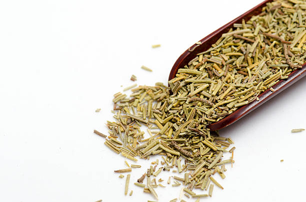 istock Dry rosemary in wooden spoon isolated on white background 628508562