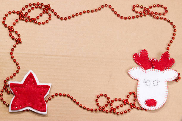 istock White Deer and red star of felt on cardboard. 628508908