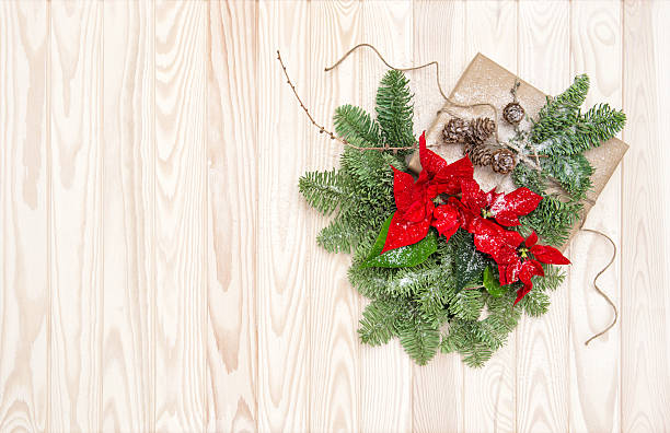istock Christmas decoration Pine branches wrapped gift poinsettia flowers 628515434