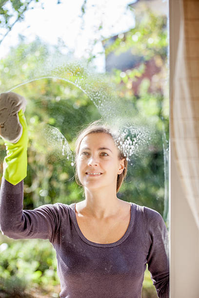 istock Young Woman Cleaning Windows 628517686